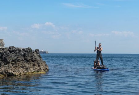 Tarkhankut, Crimea-may 25, 2018: Seascape with young people in the boatのeditorial素材