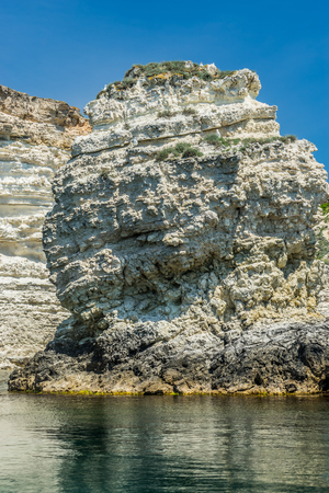 Crimean landmark: Cape Tarkhankut with beautiful rocks on the background of the sea and sky.の写真素材