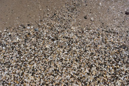 Natural background of small colored pebbles on the beachの写真素材