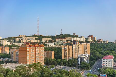 Vladivostok, Russia-July 21, 2018: Urban landscape with houses and hills against a blue skyのeditorial素材