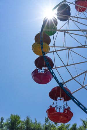 Vladivostok, Russia-July 28, 2018: Ferris wheel with colored cabins on background of blue skyのeditorial素材