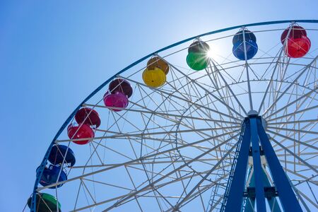 Vladivostok, Russia-July 28, 2018: Ferris wheel with colored cabins on background of blue skyのeditorial素材