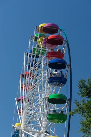 Vladivostok, Russia-July 28, 2018: Ferris wheel with colored cabins on background of blue skyのeditorial素材
