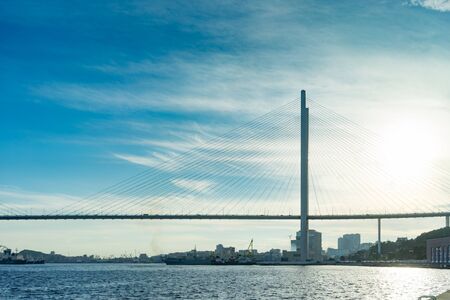 Vladivostok, Russia-August 11, 2018: Urban landscape with views of the Golden bridge in the evening.のeditorial素材