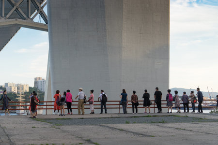 Vladivostok, Russia-August 11, 2018: Foreign tourists look at the Golden Bay and the supports of the...