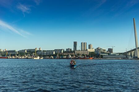 Vladivostok, Russia-August 11, 2018: Seascape overlooking the city and the boat with people.のeditorial素材