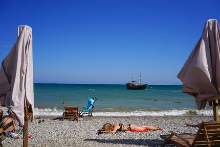 Koktebel, Crimea-June 27, 2015: Beach area of a small resort town with resting people.のeditorial素材