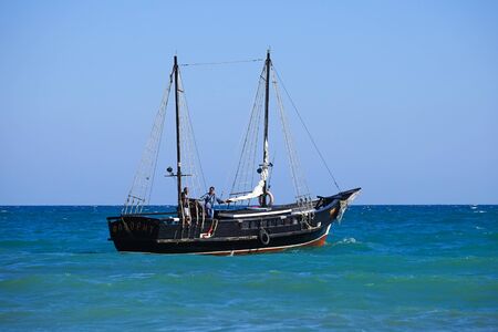 Koktebel, Crimea-June 27, 2015: Tourist ship in vintage style on the background of blue sea and horizon.のeditorial素材