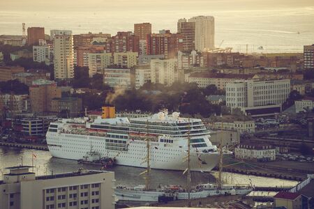 Vladivostok, Russia - September 9, 2018: Cruise ship Costa NeoRomantica in the background of the urban landscape in the evening.のeditorial素材