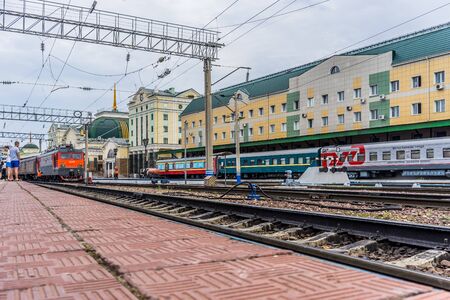 Ulan-Ude, Russia - July 17, 2018: Railway station of the city with the road, trains and people.のeditorial素材