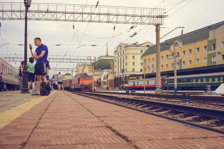 Ulan-Ude, Russia - July 17, 2018: Railway station of the city with the road, trains and people.のeditorial素材