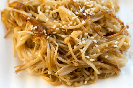 fried enoke mushrooms in soy sauce on a white plate. Asian foodの写真素材