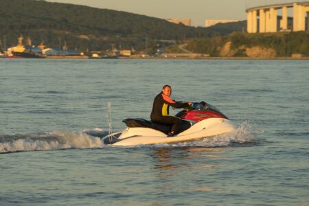 Vladivostok, Russia-September 16, 2018: A man in a waterproof suit riding on a sea jet ski.のeditorial素材