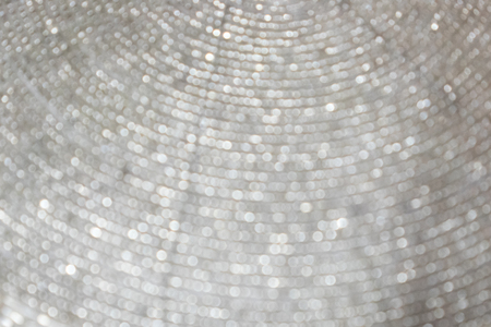 Blurred festive silver background with lots of bokeh. For design and networking.の写真素材