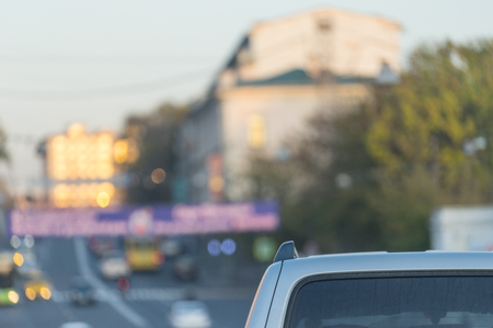 Cityscape with parts of the car on the blurred background of the road. For design and networking.の写真素材