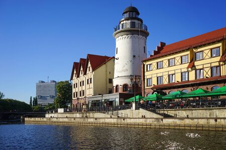 Kaliningrad, Russia - May 11, 2016: The modern landmark of the city with the lighthouse and buildings in the old style on the banks of the Pregolya river.のeditorial素材