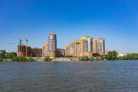 Novosibirsk, Russia-July 16, 2018: urban landscape with views of the Ob river and coastline with houses against a blue sky.のeditorial素材