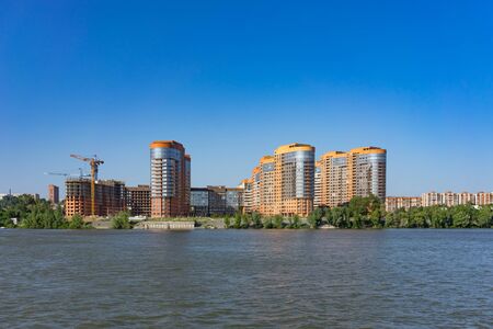 Novosibirsk, Russia-July 16, 2018: urban landscape with views of the Ob river and coastline with houses against a blue sky.のeditorial素材