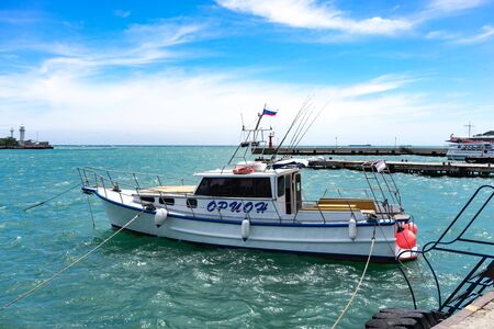Yalta, Crimea-may 30, 2018: seascape with a boat on the background of the sea.のeditorial素材