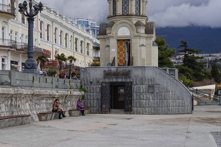 Yalta, Crimea-March 13, 2015: The city landscape of the embankment with a chapel and buildings.のeditorial素材