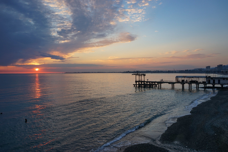 Amazing sunset on the ocean. View of dramatic cloudy sky and reflection of the sunlight on water.の写真素材