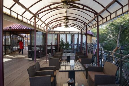 Yalta, Crimea-March 14, 2015: Open veranda cafe with interior and people.のeditorial素材