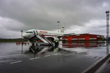 Murmansk, Russia-June 7, 2014: Landscape with plane and people going to air transport.のeditorial素材