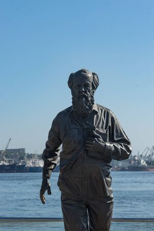 Vladivostok, Russia-July 28, 2018: urban landscape with a monument to Solzhenitsyn on the background of the sea.のeditorial素材