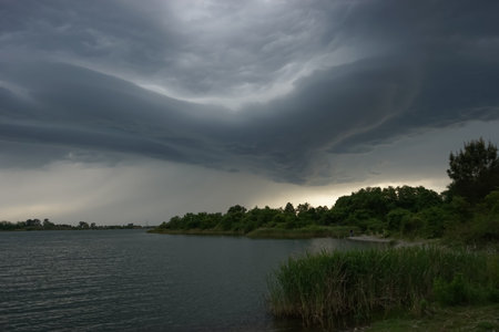 Dramatic landscape with storm clouds over the lake.
