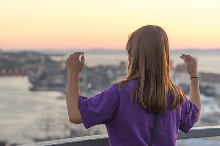 Vladivostok, Russia-September 9, 2018: Portrait of a tourist girl on a blurred background of the city landscape.のeditorial素材