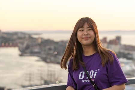 Vladivostok, Russia-September 9, 2018: Portrait of a tourist girl on a blurred background of the city landscape.のeditorial素材