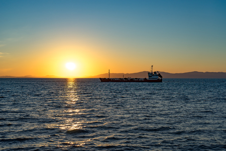 Seascape with beautiful sunset and ships on the horizon.の写真素材