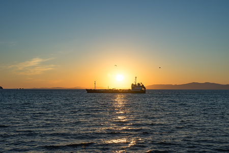 Seascape with beautiful sunset and ships on the horizon.の写真素材