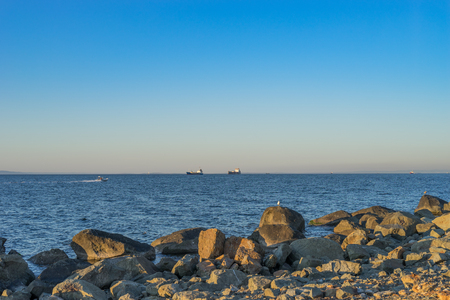 Seascape with beautiful sunset and ships on the horizon.の写真素材