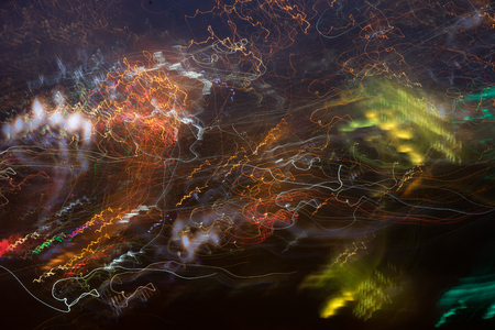Abstract background with light lines of different colors on a dark backgroundの写真素材