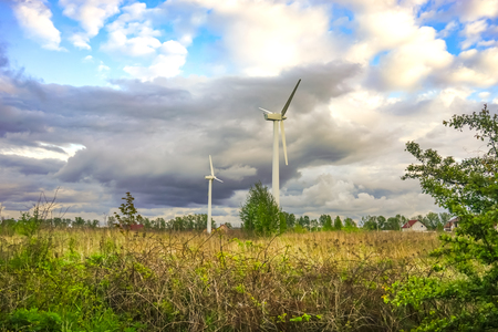 Wind power in the landscape, under a cloudy sky.の写真素材