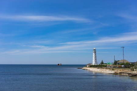 seascape with beautiful white lighthouse against blue sky on Cape Tarkhankut, Crimea.の写真素材