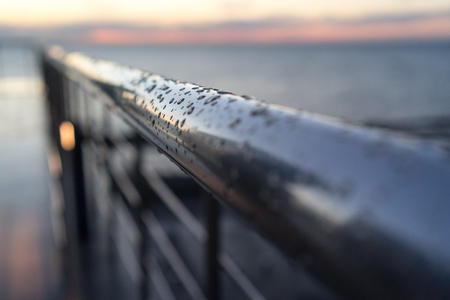 metal fence on the site of Adler station with rain drops on the surface.の写真素材