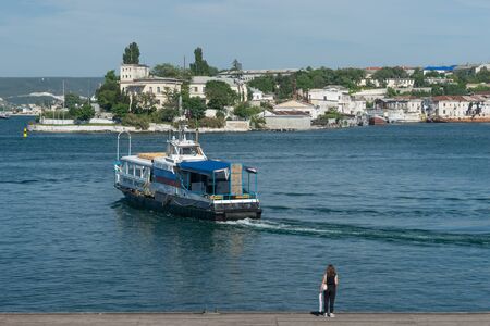 Sevastopol, Crimea-may 31, 2018: Pleasure boat on the background of the sea and the urban landscape.のeditorial素材