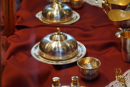 Silverware with blackened floral patterns on a red background.の写真素材