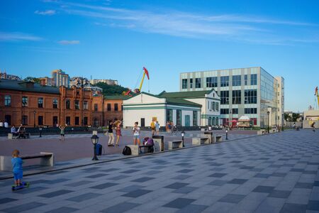 Vladivostok, Russia-August 11, 2018: Landscape of the modern city with people on the background of attractions.のeditorial素材