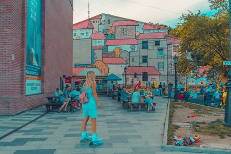 Vladivostok, Russia-August 11, 2018: Landscape of the modern city with people on the background of attractions.のeditorial素材