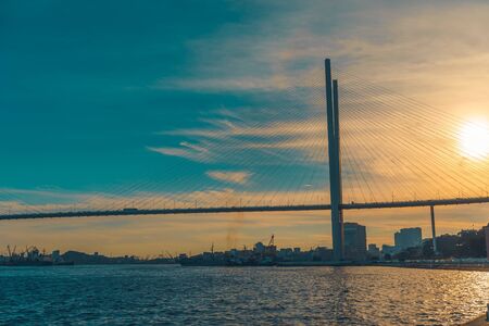 Vladivostok, Russia-August 11, 2018: Modern bridge on the background of the urban landscape and the sea.のeditorial素材