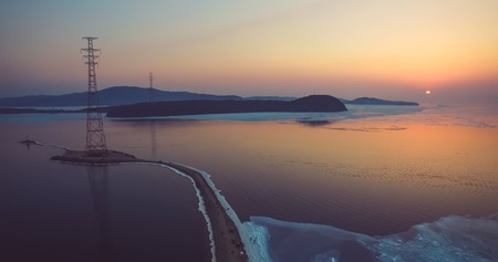 Aerial view of the sea landscape with sunset and ice floes on the seaの写真素材