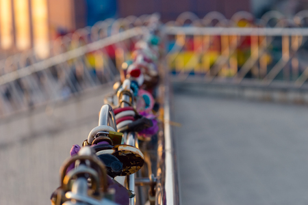 Background with lots of colorful locks on the bridge railing.の写真素材
