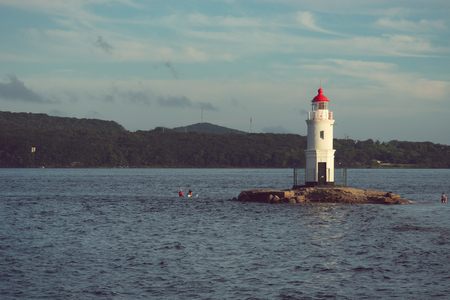 Vladivostok, Primorsky Krai-August 26, 2018: Marine landscape with views of the white Tokarevskiy lighthouse against the blue sea.の写真素材