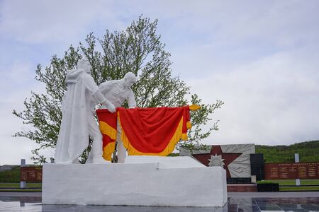 Murmansk, Russia-June 06, 2015: Memorial Of the valley of Glory in the vicinity of the Arctic city. Monument with two soldiers and a red flag.のeditorial素材
