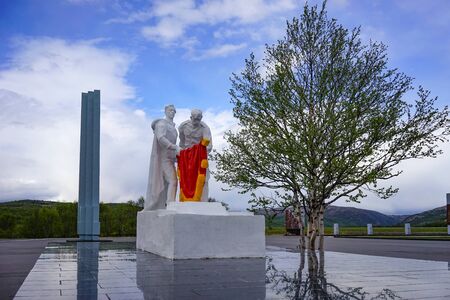 Murmansk, Russia-June 06, 2015: Memorial Of the valley of Glory in the vicinity of the Arctic city. Monument with two soldiers and a red flag.のeditorial素材