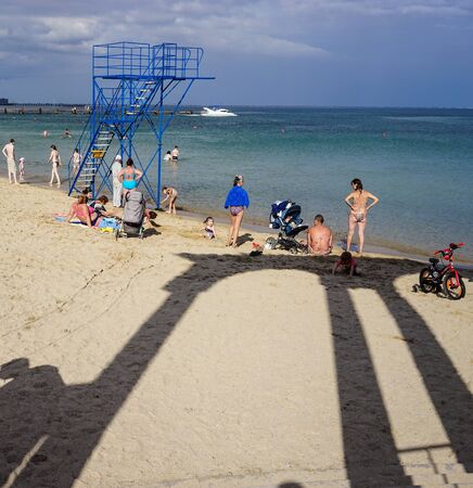 Evpatoria, Crimea-June 20, 2015: city promenade by the sea with the beach and vacationers.のeditorial素材
