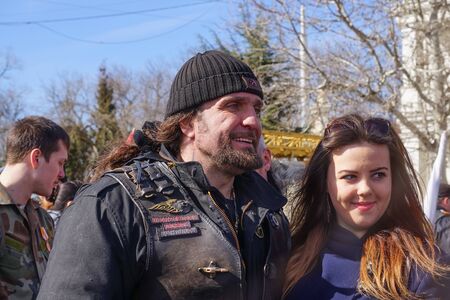 Sevastopol, Crimea-March 16, 2015: The famous Russian biker named Surgeon photographed with a young girlのeditorial素材